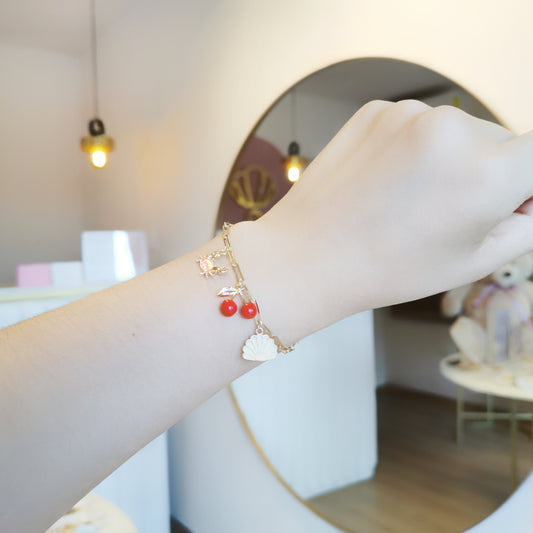 PULSERA DIJES CEREZA, CANGREJO Y CONCHA